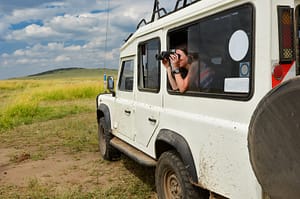Woman taking photos on African safari